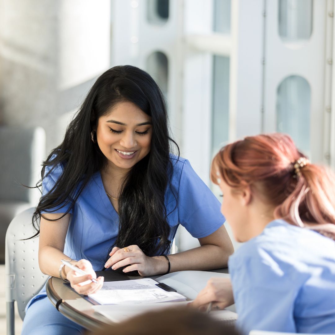 Two nursing students studying together.