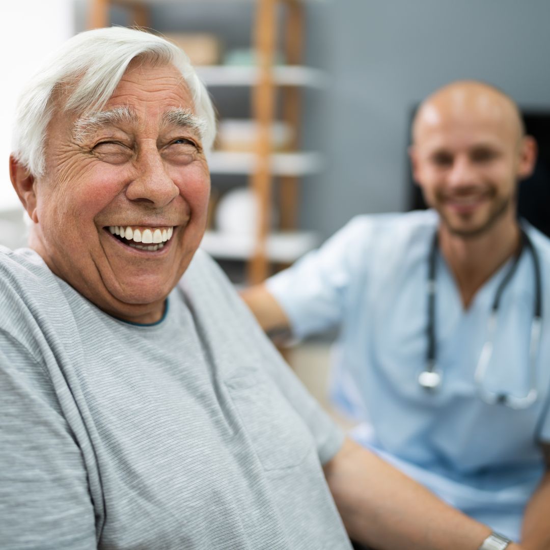 smiling patient sitting next to a male nurse