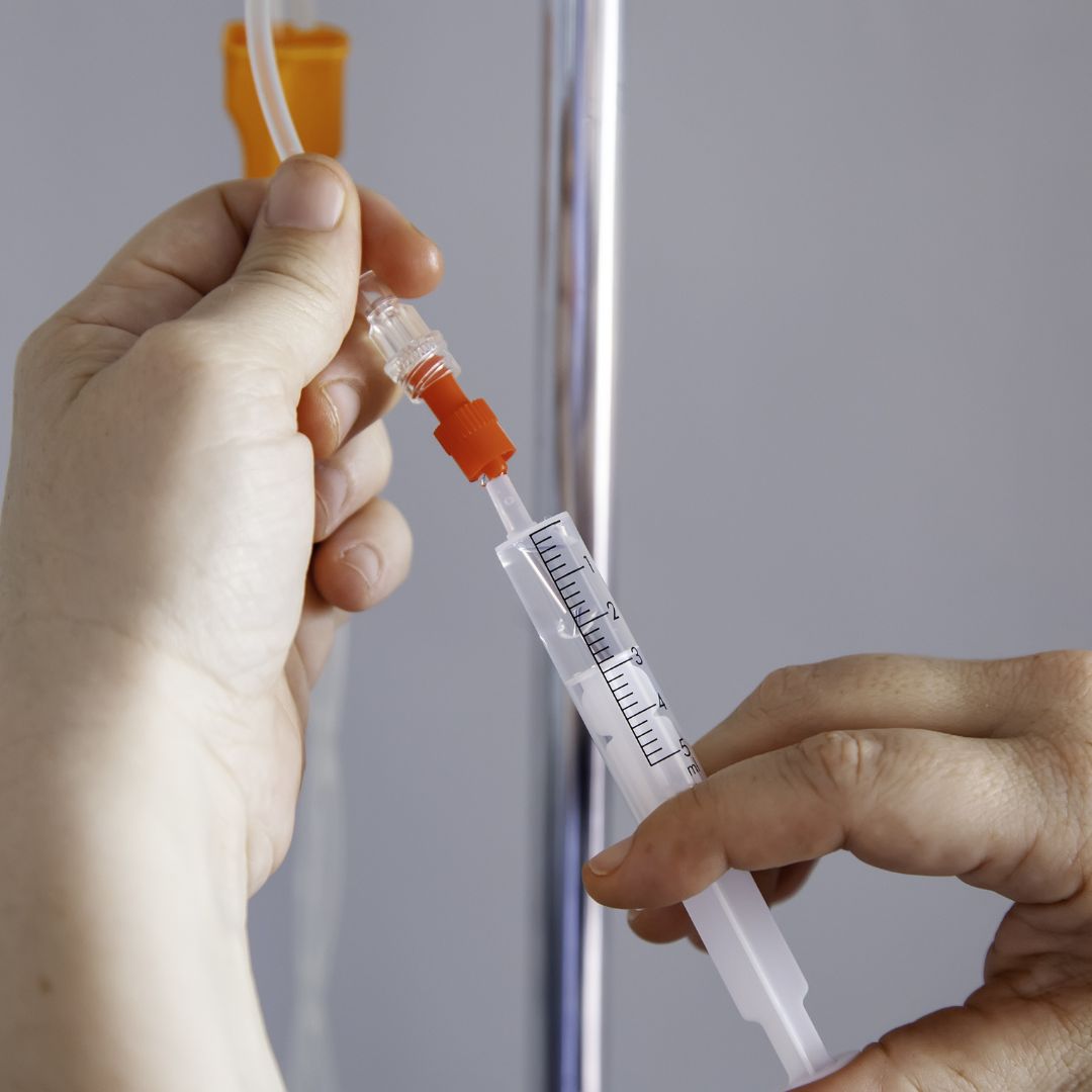 Nurse readying IV line