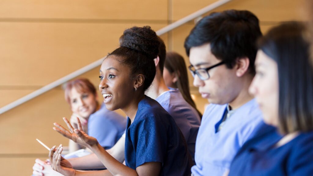 Nursing student asking question in lecture hall
