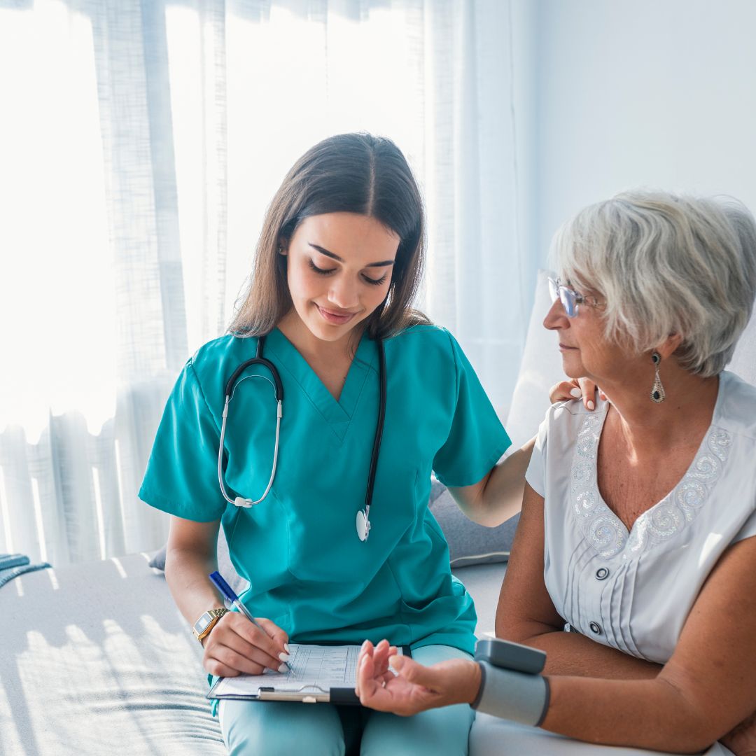 Nurse sitting with patient 