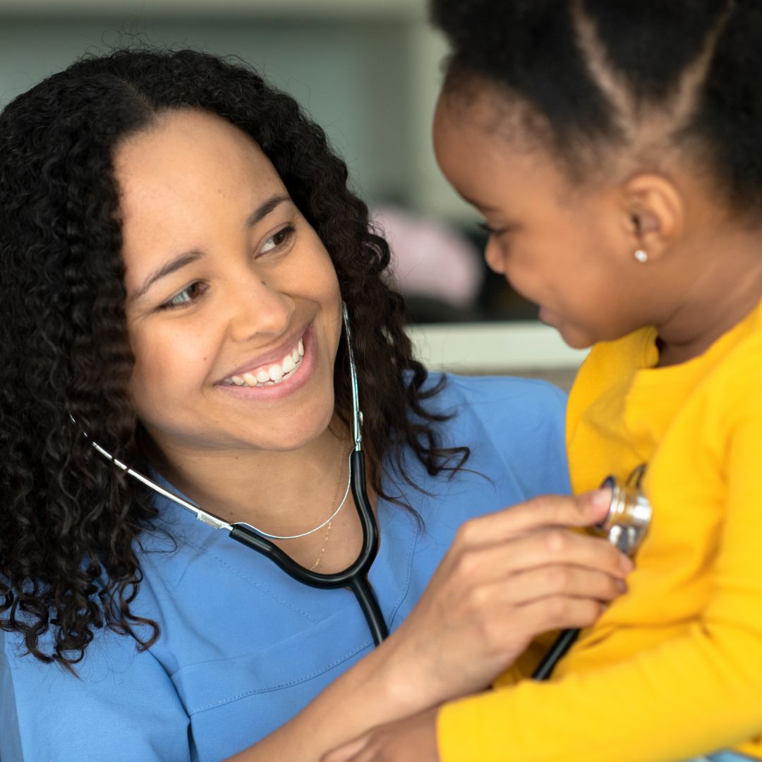 nurse checking a childs heartbeat