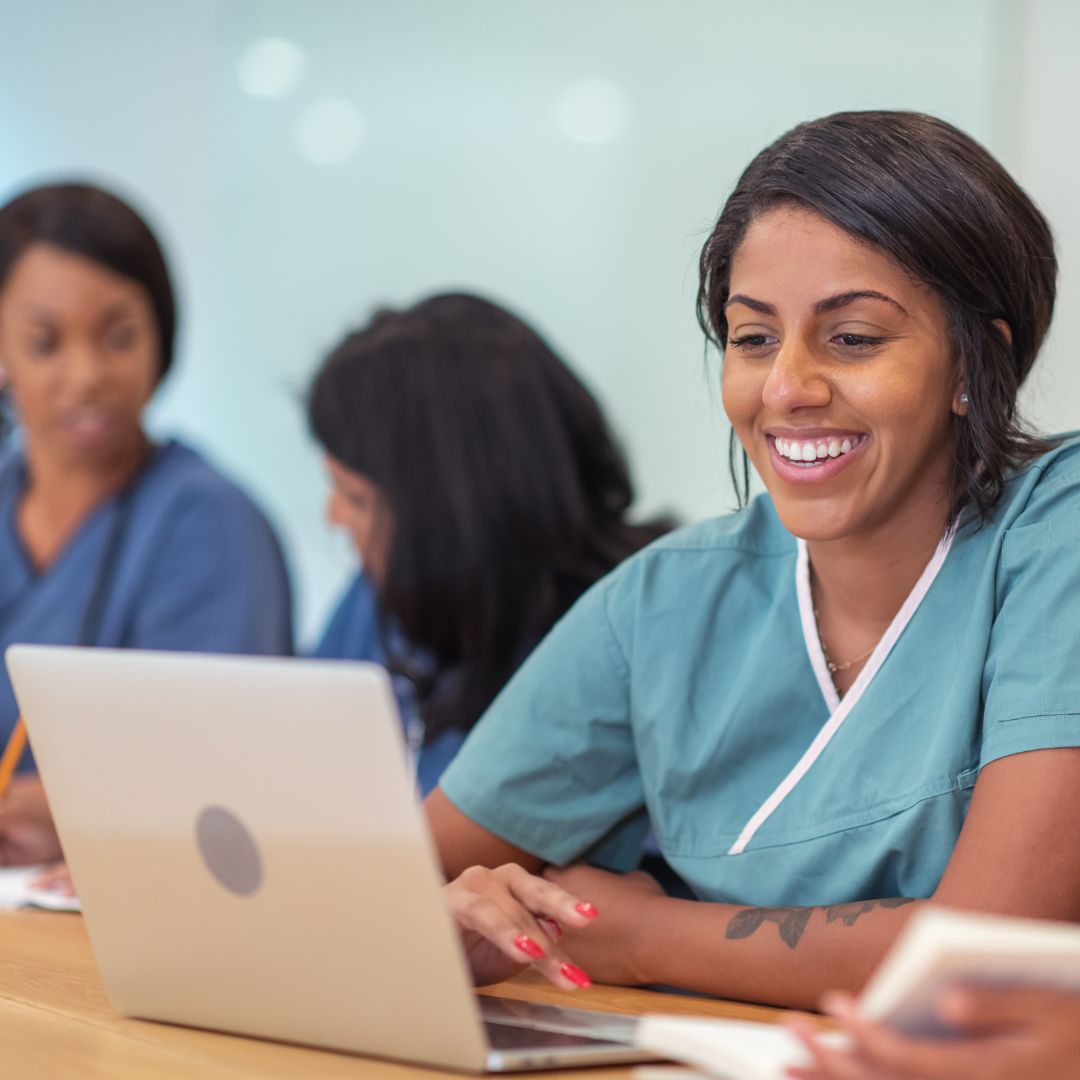 nurse looking at a computer