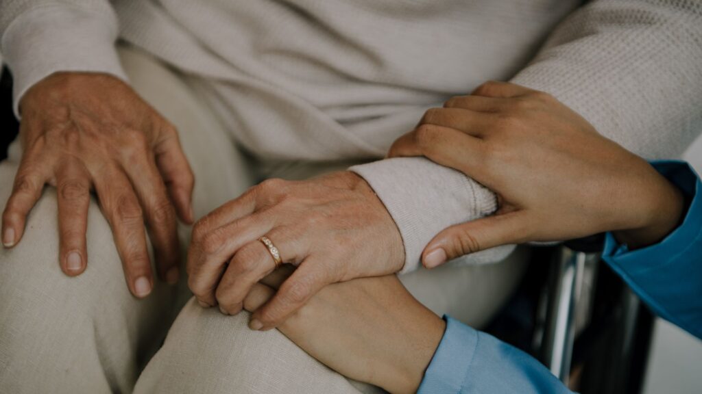 nurse holding an old womans hands
