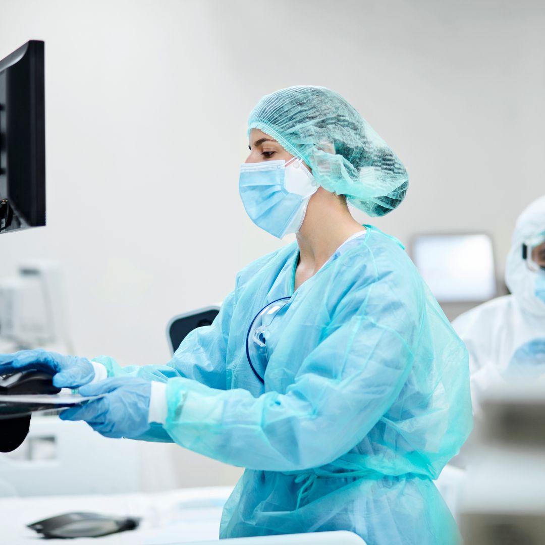 A nurse assisting in surgery. 