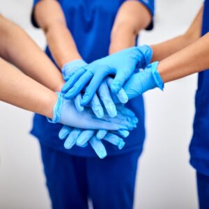 nurses with hands together