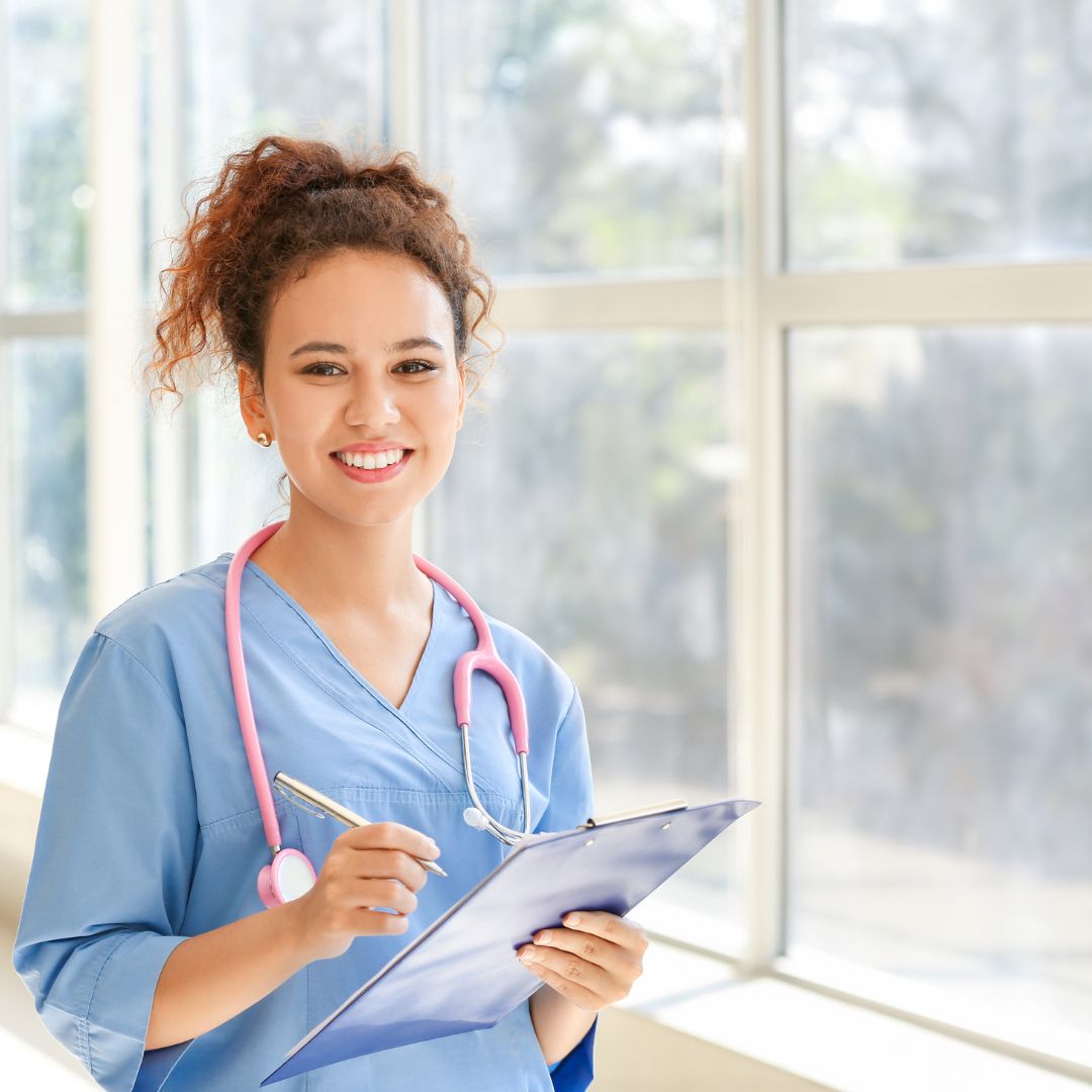nurse smiling near a window