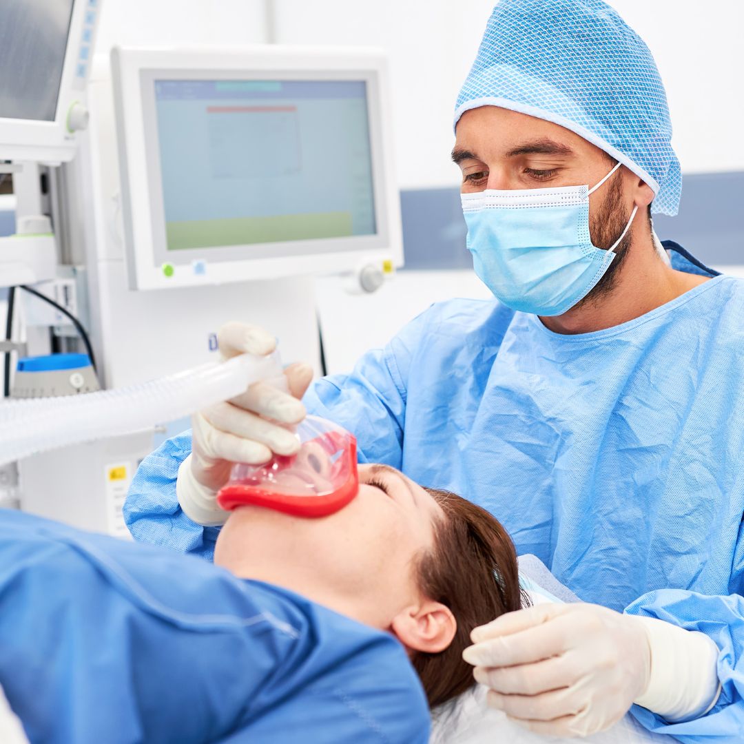 nurse administering oxygen mask to patient