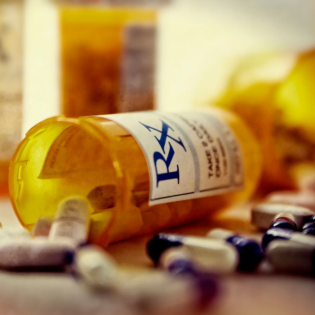 prescription bottles next to medicine pills
