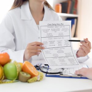 A nurse pointing to a nutrition guide