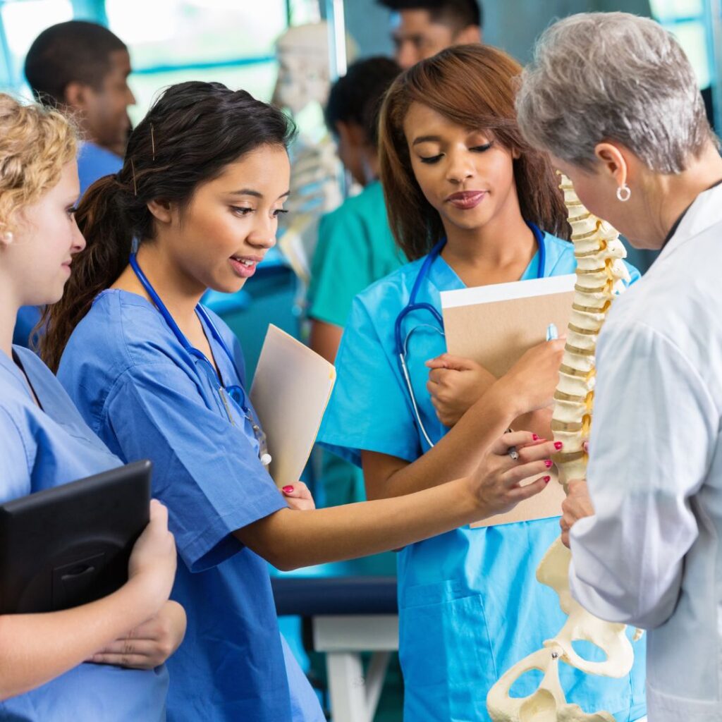 nursing students looking at a skeleton