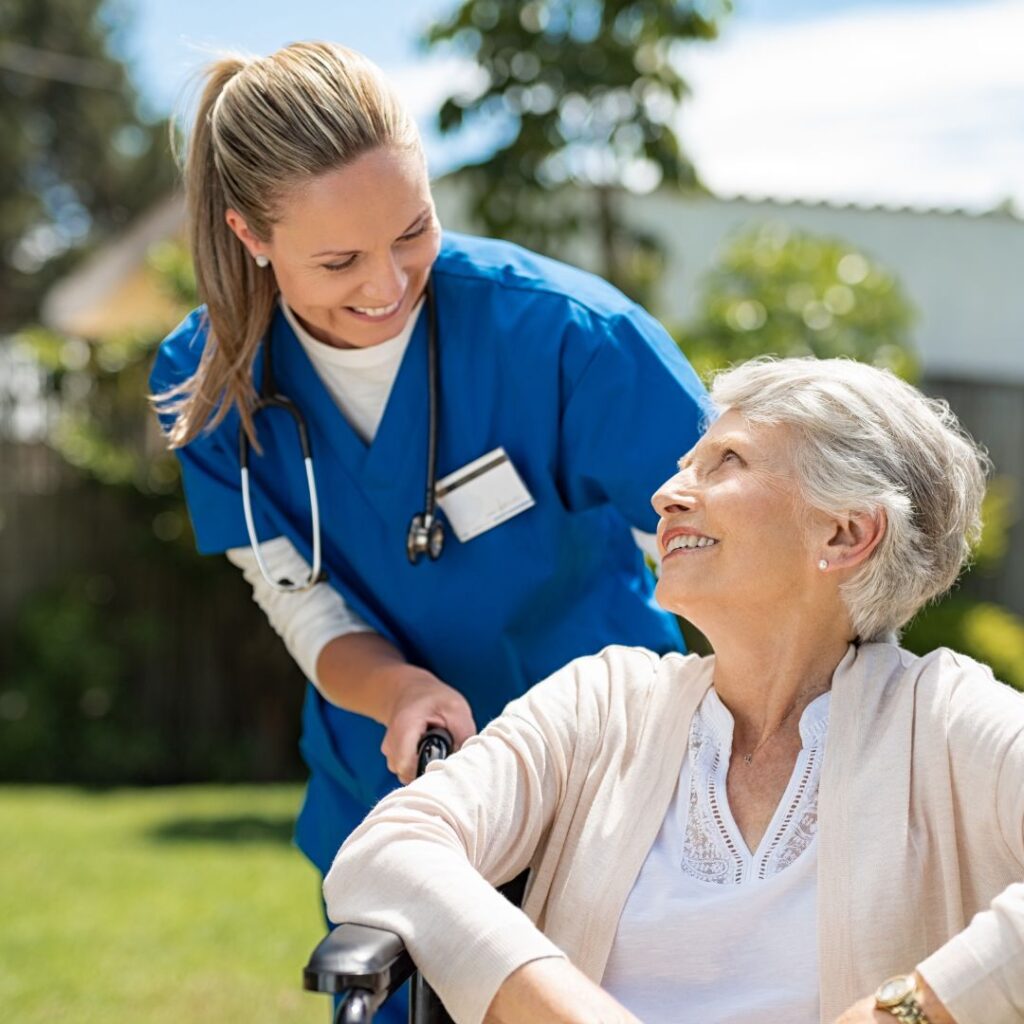 a pct pushing a woman in a wheel chair