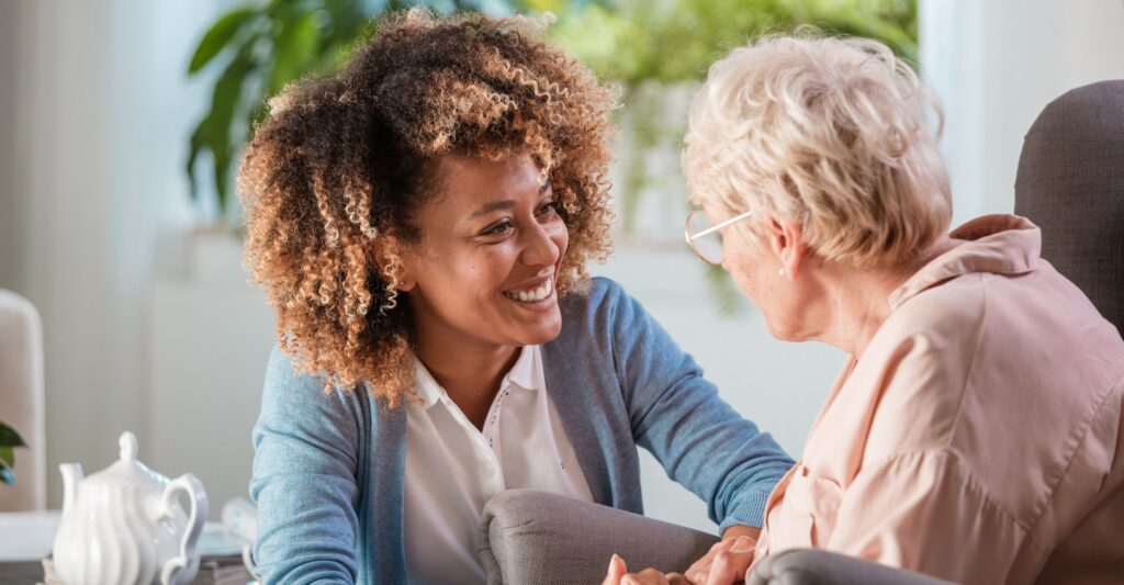 a young nurse talking with an older woman