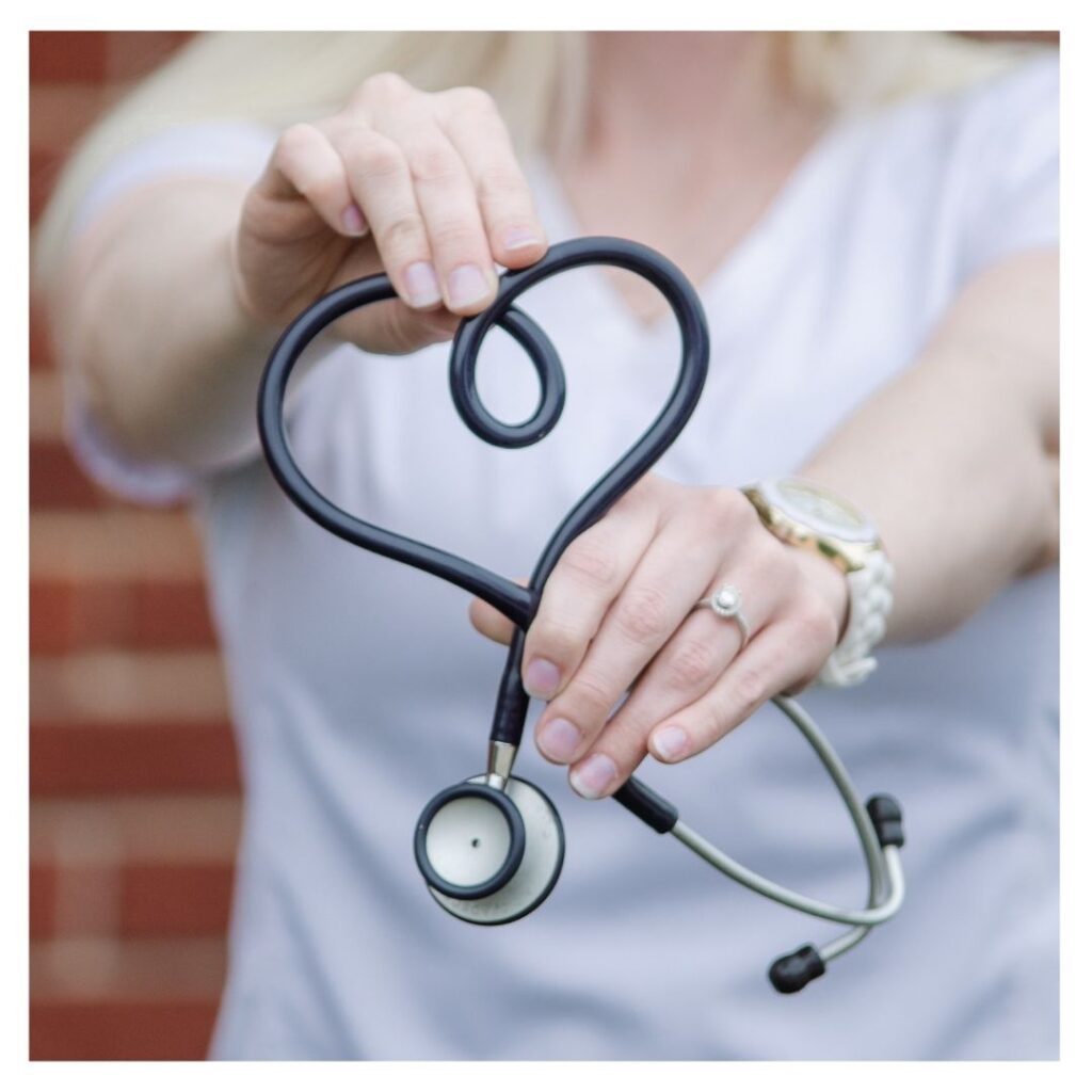Nurse holding a stethoscope in the shape of a heart