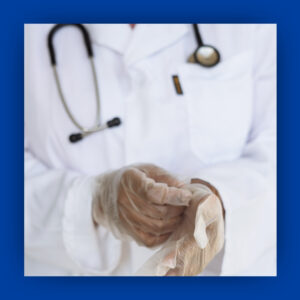 Medical worker putting on gloves