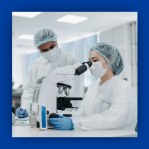 Nurses looking in a microscope