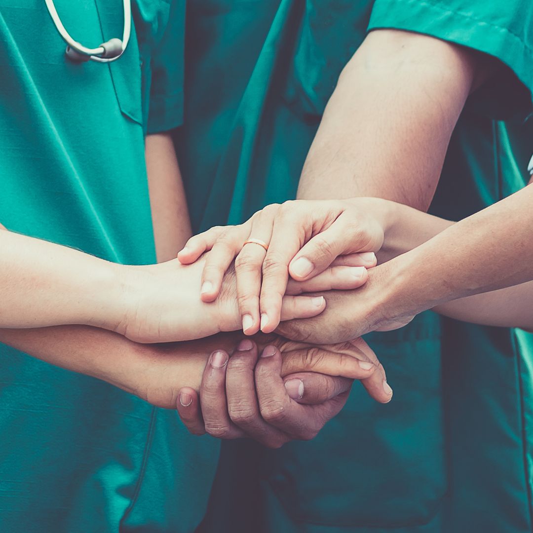 nurses putting hands in together