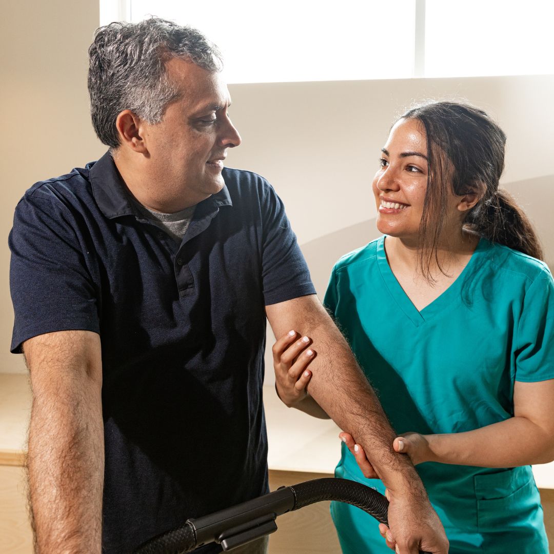 nurse helping man walk