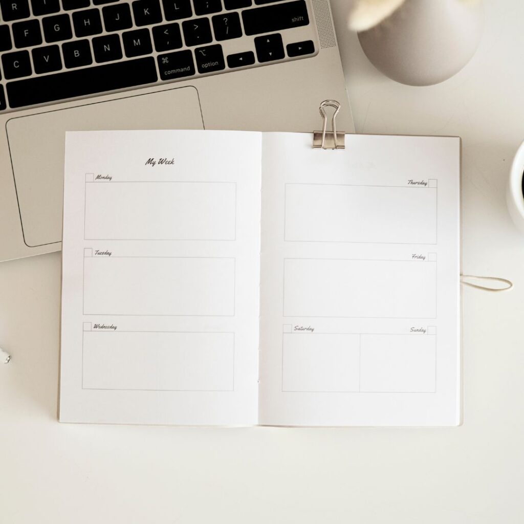 Weekly planner and laptop