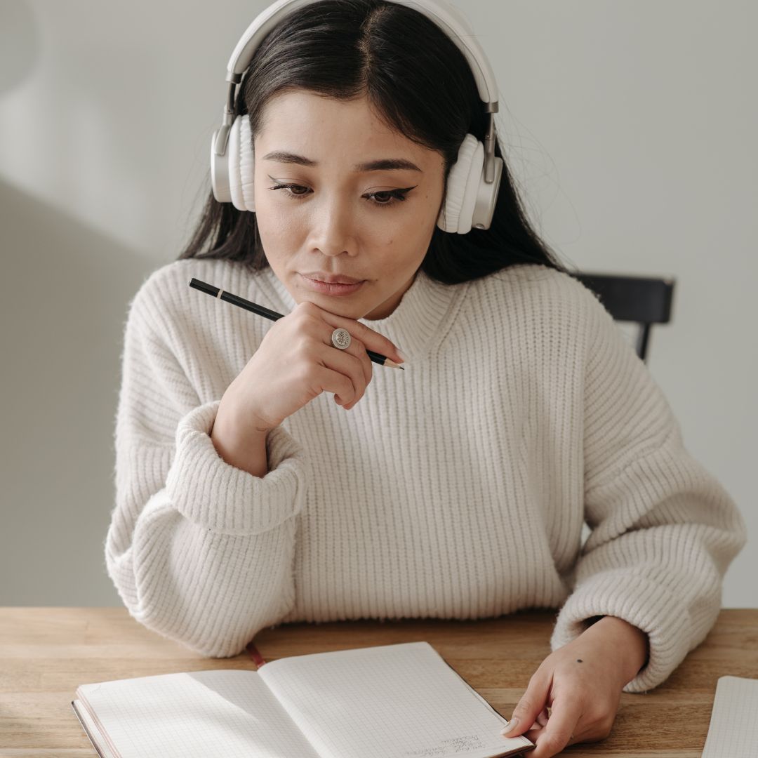 Woman studying with headphones on