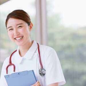 Nurse smiling holding clipboard