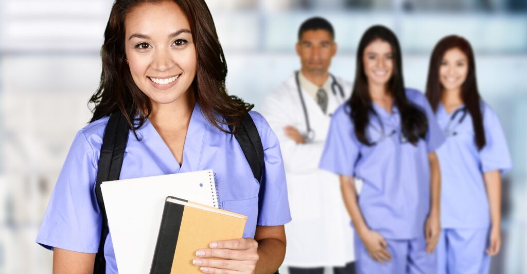 Nurses & doctor smiling holding textbooks