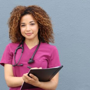 Nurse smiling & holding clipboard