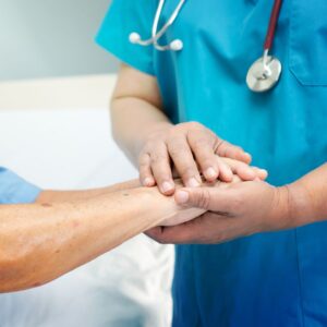 Nurse holding patients hands