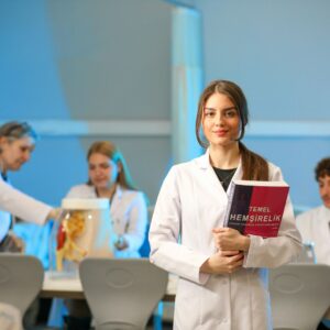Nurse holding textbook in front of peers
