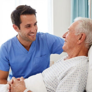 A close-up photo showing a patient care tech smiling and making eye contact