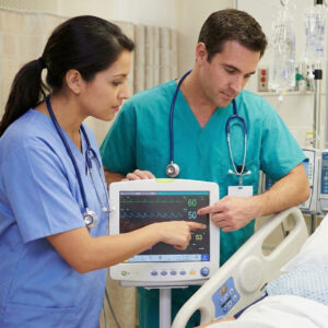 An LPN and doctor collaborate over a patient monitor